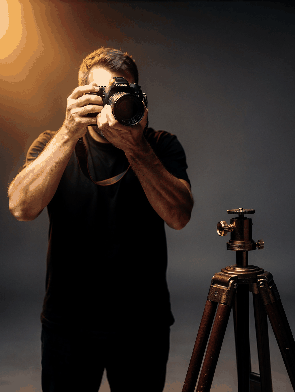 Lead photographer calibrating a macro iris lens with chin-rest stabilization in the dark studio